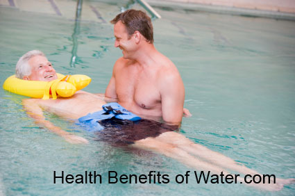 Elder person being helped by a water therapy specialist