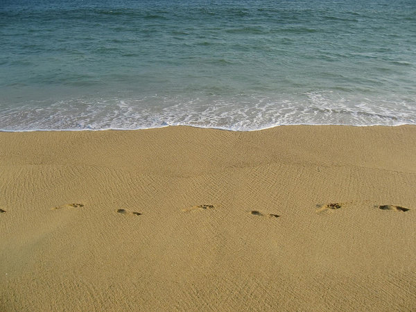 Seawater, beach and footprints in Acapulco
